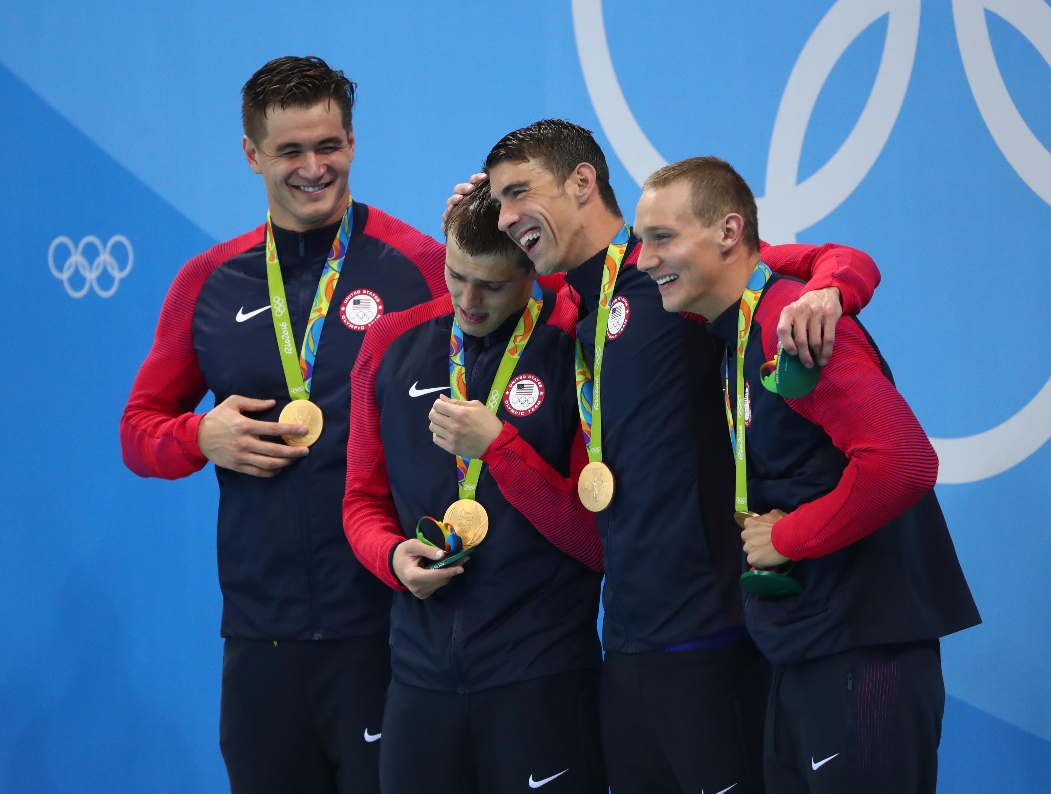 Nathan Adrian, Ryan Held, Michael Phelps and Caeleb Dressel celebrate with their gold medals after the men's 4x100m freestyle relay final in the Rio 2016 Summer Olympic Games at Olympic Aquatics Stadium on Aug. 7, 2016.