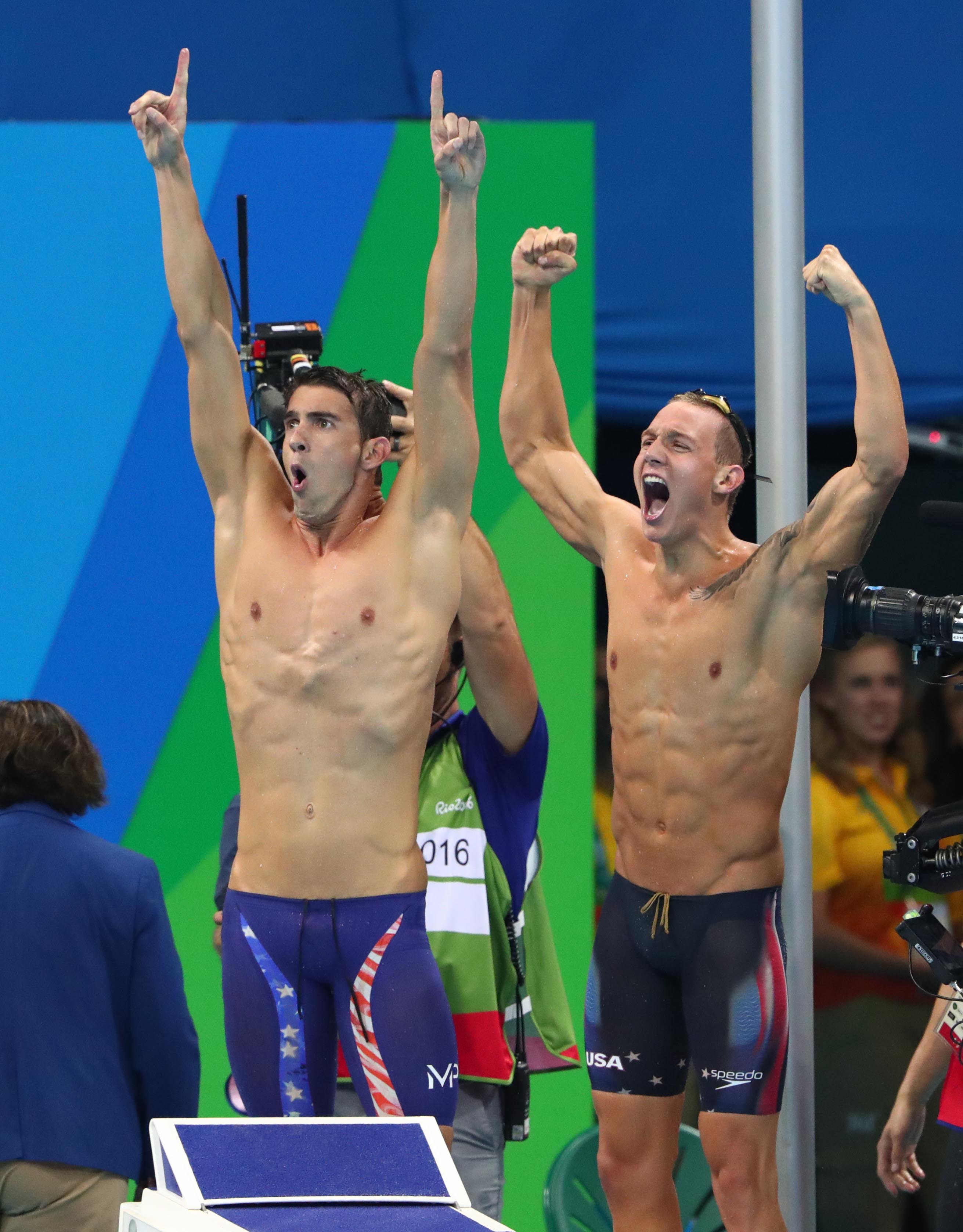 Michael Phelps and Caeleb Dressel (USA) celebrate after winning the men's 4x100m freestyle relay final in the Rio 2016 Summer Olympic Games at Olympic Aquatics Stadium on Aug.  7, 2016.