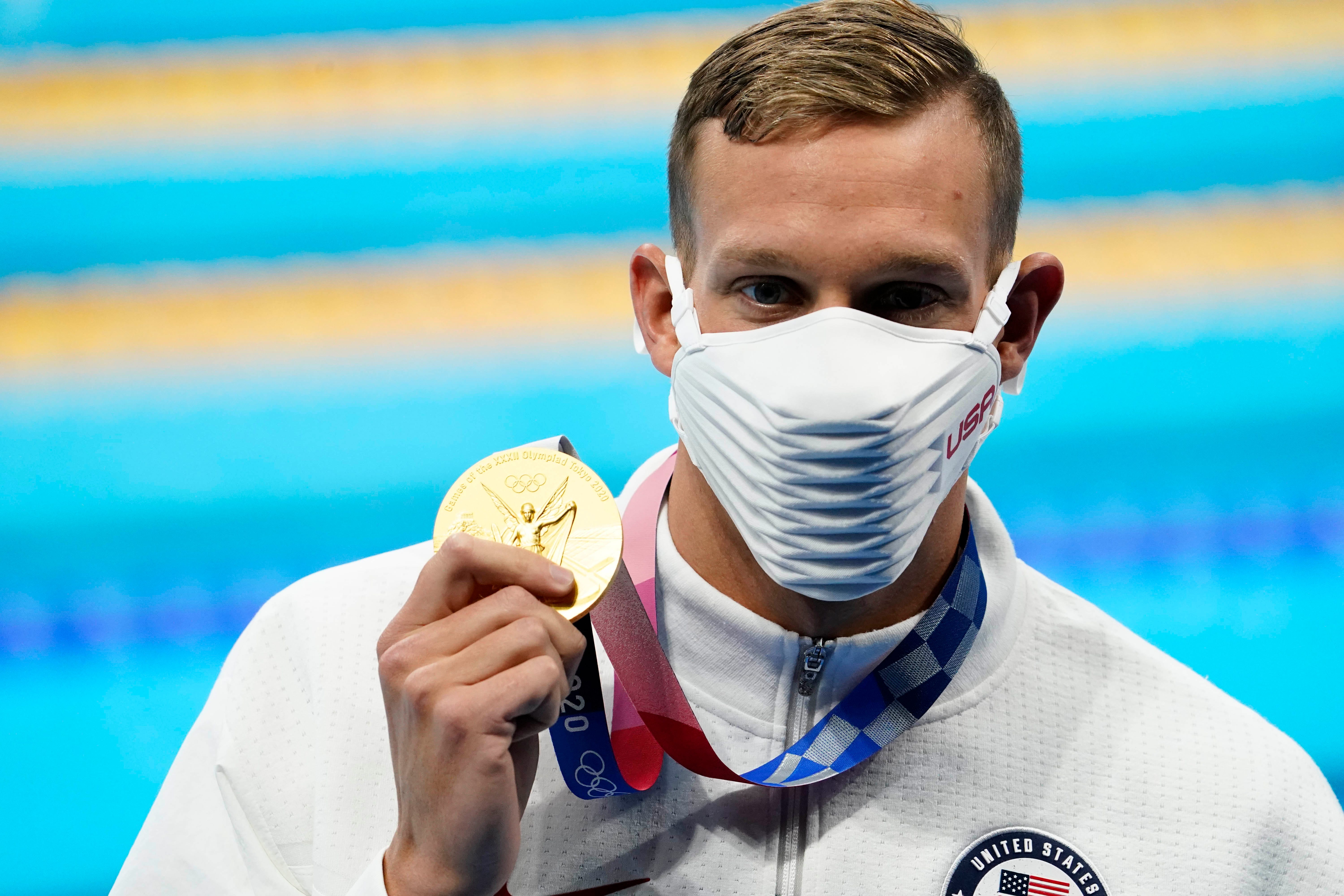 Caeleb Dressel (USA) with his gold medal during the medals ceremony for the men's 100m butterfly during the Tokyo 2020 Olympics.